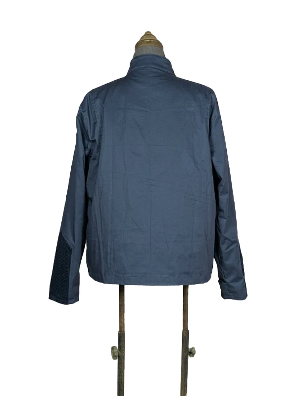 Rear view of the dark navy blue lightweight Steve Rogers civilian jacket from Captain America: The Winter Soldier on a studio dress form.