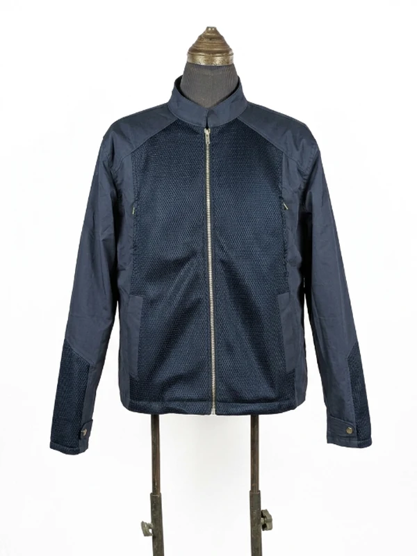 Front product shot of the screen-accurate Captain America Winter Soldier Steve Rogers navy blue jacket featuring textured chest panels and a center zipper.