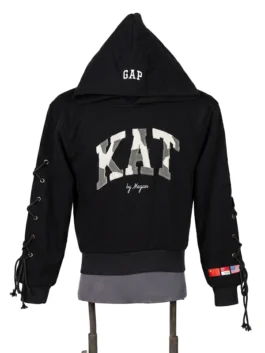 Front view of a premium black fleece pullover hoodie on a mannequin featuring large camo varsity lettering across the chest and custom lace-up sleeves.