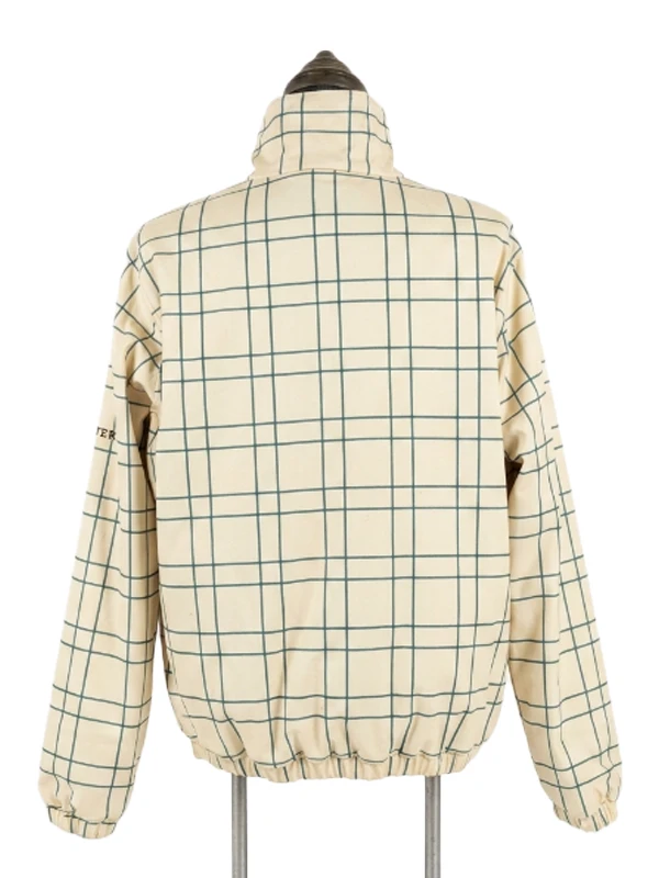 Rear view of the cream and green grid windowpane check pattern side of the Masters reversible quarter-zip jacket displayed on a dress form.