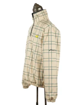 Three-quarter left side view of the cream check patterned side of the Masters reversible jacket highlighting the sleeve and chest embroidery.