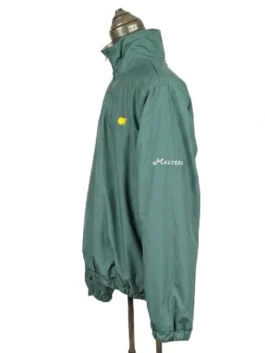Side profile display of the solid green side of the Masters reversible quarter-zip jacket showcasing the embroidered arm detail.