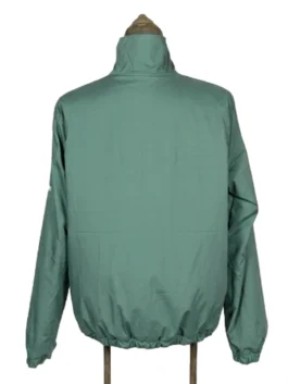 Full back view of the solid green side of the Masters reversible golf jacket on a vintage mannequin stand.