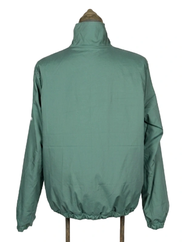 Full back view of the solid green side of the Masters reversible golf jacket on a vintage mannequin stand.