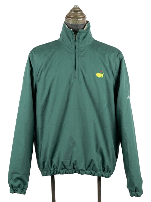 Front perspective of the solid tournament green side of the Masters reversible quarter-zip jacket with yellow chest emblem.
