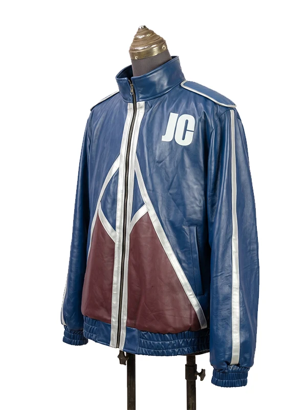 Three-quarter side view of the blue faux leather Mortal Kombat 2 Johnny Cage (Karl Urban) jacket, showing the white "JC" letters on the chest, a silver striped sleeve, and maroon geometric paneling.