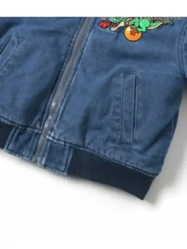 Close-up detail of Dragon Ball x BREEZE Denim Boa Jacket showing zipper closure and front pocket on blue denim