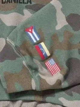 Gap Katseye Daniela Hoodie with camo fleece body, flag embroidery on sleeves, hooded collar, and rib cuffs