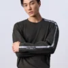 Jung Kook Calvin Klein Stripe Shirt with black fleece body, full sleeves, and clean racing-inspired style