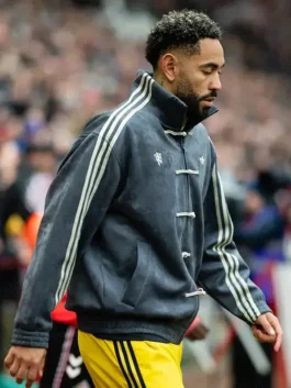 Close-up of grey Adidas CNY jacket showing knot button closure, side pockets, Adidas Trefoil and Man United crest clearly