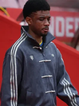 Manchester United player in grey Adidas CNY jacket showing knot buttons, stand-up collar and Three Stripes at Matchday 36