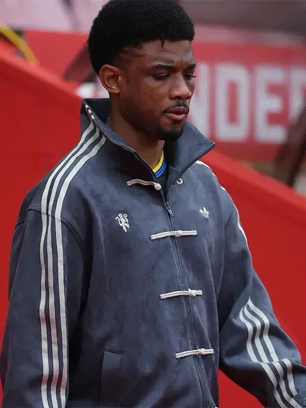 Manchester United player in grey Adidas CNY jacket showing knot buttons, stand-up collar and Three Stripes at Matchday 36