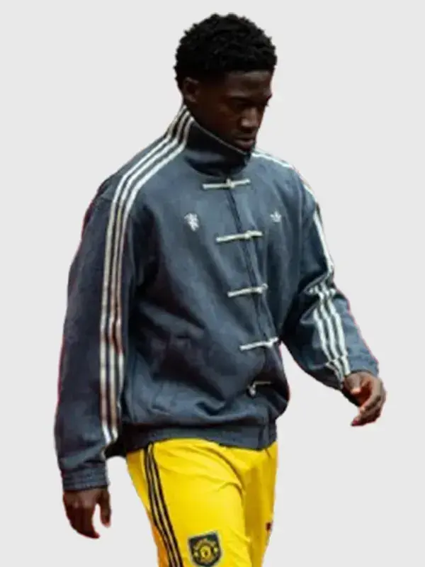 Manchester United player in grey Adidas CNY jacket on white background showing Three Stripes on both sleeves and knot buttons