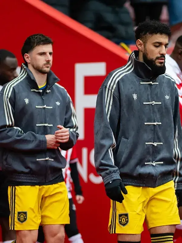 Two Man United players in matching grey Adidas CNY jackets walking during Matchday 36 Sunderland vs Man United walkout