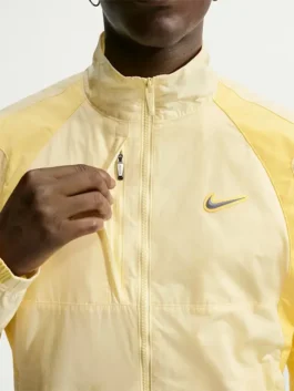 NOCTA Northstar Yellow Track Jacket front view with yellow track design and stand collar detail