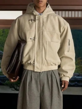 Beige Shinzo Shige canvas clasp bomber jacket flat lay with trousers and accessories on patterned rug