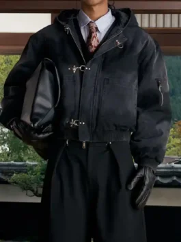 Model wearing black Shinzo Shige canvas clasp bomber jacket with gloves and layered streetwear outfit