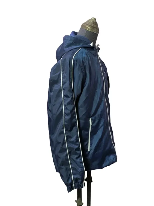 Side profile of the BTS Keep Swimming Blue Jacket displaying the elasticized cuffs and secure side seam pockets.