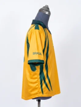 Side view of the yellow CJ x Nike Total 90 Retro Brasil Jersey on a mannequin, showing the green 