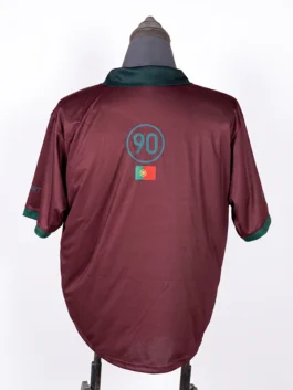 Rear view of the maroon CJ x Nike Portugal Total 90 Retro Jersey, featuring a central green circle with the number 90 and the Portugal national flag underneath.