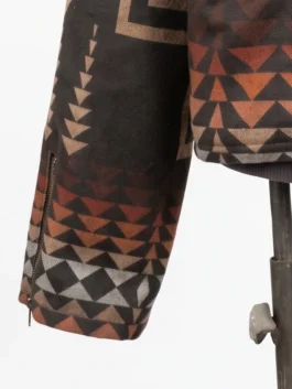 Close-up of the sleeve cuff on a Western geometric print jacket featuring a zippered cuff expansion and multi-colored triangular patterns.