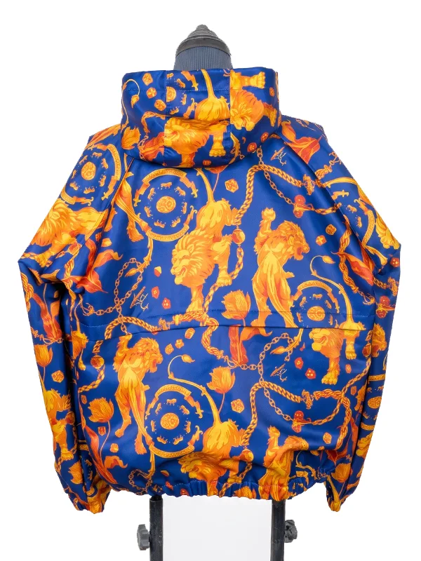 Rear-facing product image of the hooded Netherlands Anthem Jacket on a display stand, showcasing the symmetrical, repeating orange royal chain and lion graphics running along the back panels and hood.