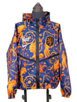 Frontal studio shot of the FIFA World Cup 2026 Netherlands Anthem Jacket on a mannequin, featuring a full-length black zipper, a dark chevron chest line, the official KNVB shield, and white athletic branding.