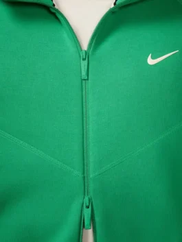 NOCTA Tech Fleece Full Zip Hoodie Stadium Green closeup showing zipper detail and premium fabric texture