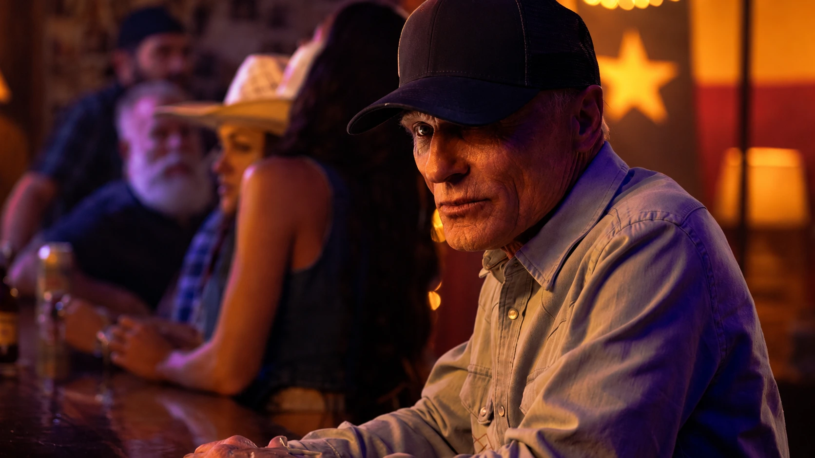 Ed Harris as Everett McKinney sitting at bar in Rio Paloma with Texas flag in background in Dutton Ranch Season 1 2026 Paramount Plus