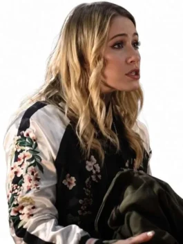 Black and white satin All Night Wrong Maria Bakalova Varsity Jacket featuring floral details, a rib knitted collar, and front zipper closure.