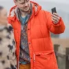 Close-up of the orange parachute fabric Brassic Tom Hanson Puffer Hooded Jacket showcasing the hooded collar and padded puffer design.