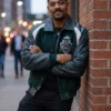 Green wool body with leather sleeves Comic-Con 2026 Aaron Pierre Varsity Jacket highlighting four practical storage pockets.