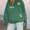 Close-up of the green fleece Dandy What If Oversized Lux Hoodie detailing the hooded collar and rib knitted cuffs.