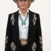 Close-up front view of the black suiting Dutton Ranch Annette Bening Floral Blazer detailing the lapel collar and front buttoning.