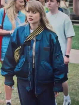 Close-up view of the blue satin Angourie Rice Finding Emily Bomber Jacket detailing the shirt collar and zip closure.