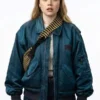 Full front profile of the blue satin Angourie Rice Finding Emily Bomber Jacket highlighting three convenient utility pockets.