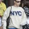 Close-up front profile of the grey fleece Hailey Bieber NYC Sweatshirt detailing the round neck collar and fine stitching.