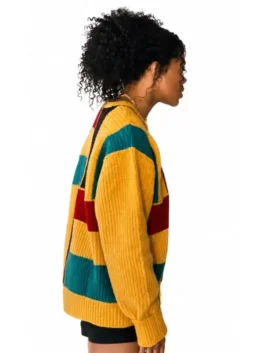 Side view of a model wearing the Keke Palmer The Burbs Colorblock Sweater showing the full length sleeves and snug cuffs.