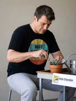 Black polyester Nathan Fillion Comic-Con 2026 Best Gardner Ever T-Shirt showing round neck and pullover fit.