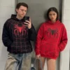 Spiderman Zendaya And Tom Holland Hoodie in red and black polyester highlighting its comfortable pullover front.
