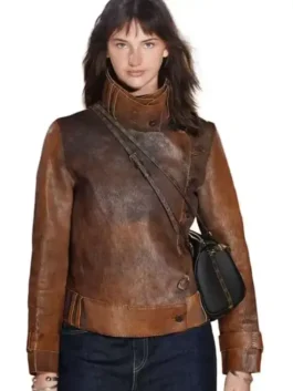 Close-up front profile of the brown leather The Bride Premiere Mia Regan Leather Jacket detailing the loop button closure and stand up collar.