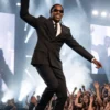 Front view of the black suiting fabric coat and pants from The Odyssey New York Premiere Travis Scott Suit.