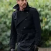 Close-up front profile of the black cotton The Runner Damian Lewis Black Coat detailing the lapel collar and waist belt.