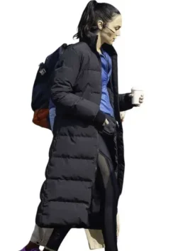 Full-length profile view of the black parachute Gal Gadot The Runner Puffer Coat showing its long silhouette and full sleeves.