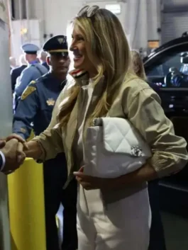 Full front view of the beige Melania Trump World Cup Final Jacket detailing three convenient storage pockets.