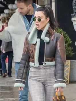 Brown real leather Kourtney Kardashian Shearling Leather Jacket featuring a stand up shearling collar and zipper closure.