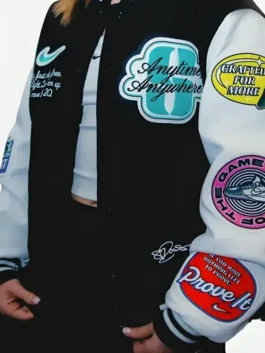 Black and white wool and PU leather Sabrina Ionescu Any Time Any Where Varsity Jacket featuring a rib knitted collar and snap tab button closure.