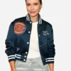 Close-up of the blue satin Sophia Bush Knicks Blue Satin Varsity Jacket detailing the rib knitted collar and snap tab front.